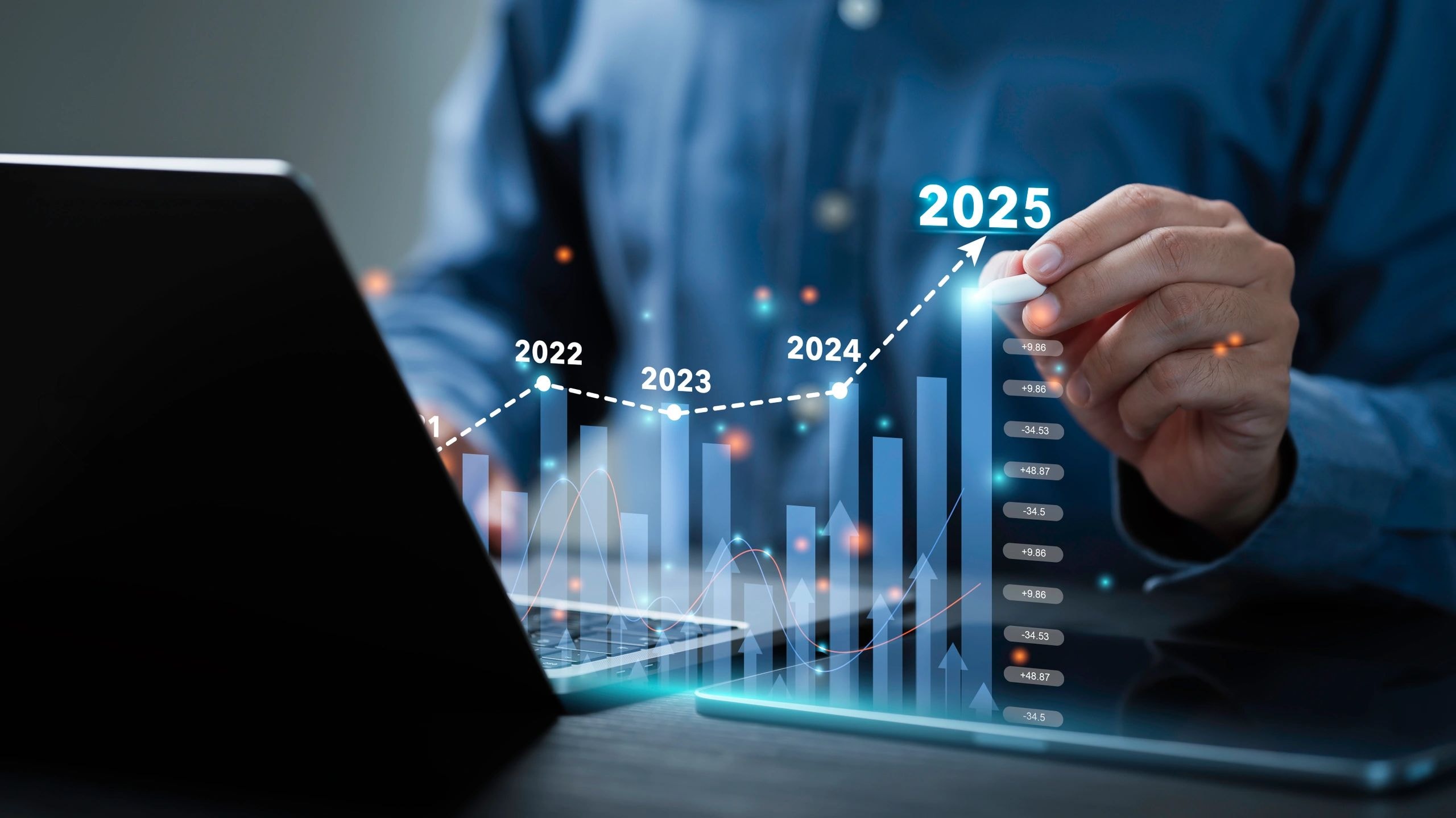 Businessman with holographic data visualization and financial charts